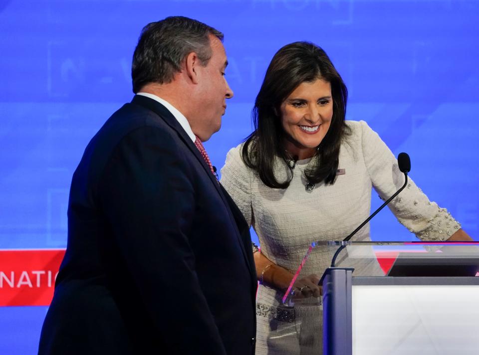 Former New Jersey Gov. Chris Christie and former South Carolina Gov. Nikki Haley during a break at the fourth Republican Presidential Primary Debate on Dec. 6. Christie suspended his campaign on Wednesday.