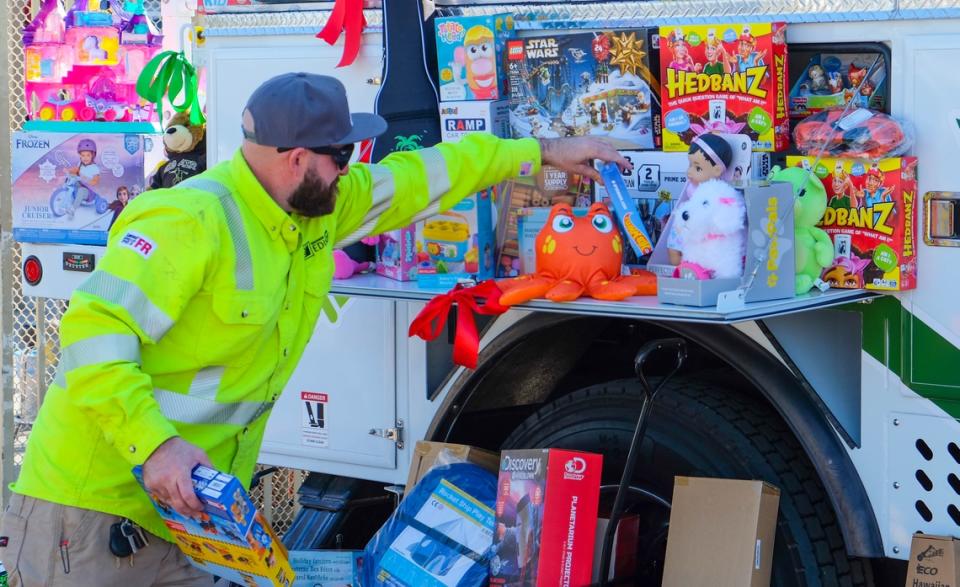 SCE's bucket truck was almost overflowing with toys of all kinds, including dolls and race cars, at one of the latest collection events. PHOTO CREDIT: LAWRENCE TSUEI
