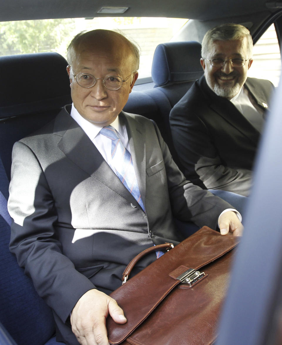 International Atomic Energy Agency (IAEA) chief Yukiya Amano, left, sits in his car as he leaves at the conclusion of his meeting with Iran's top nuclear negotiator, Saeed Jalili, unseen, as Iran's chief delegate to the IAEA Ali Asghar Soltanieh looks on, in Tehran, Iran, Monday, 21, 2012. The head of the U.N. nuclear agency arrived Monday in Tehran on a key mission that could lead to the resumption of probes by the watchdog on whether Iran has secretly worked on an atomic weapon. It would also strength the Islamic Republic's negotiating hand in crucial nuclear talks with six world powers later this week in Baghdad. (AP Photo/IRNA,Adel Pazzyar)