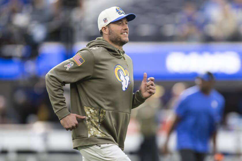 Los Angeles Rams quarterback Matthew Stafford (9) jogs on the field before an NFL football game.