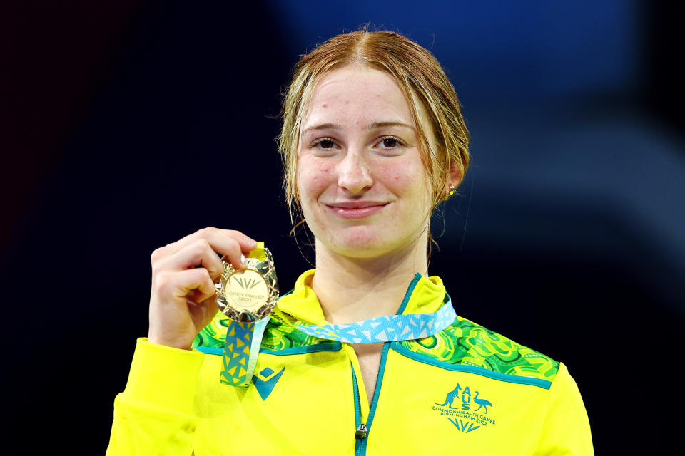 Mollie O'Callaghan, pictured here posing with her gold medal at the Commonwealth Games.