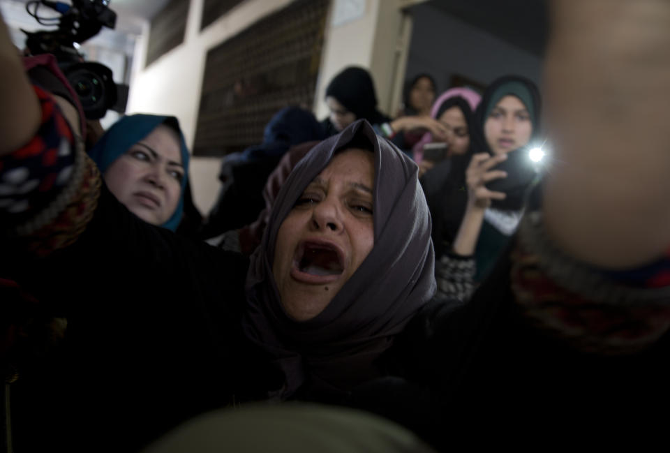 Relatives of Palestinian woman, Amal al-Taramsi, 43, who was killed by Israeli troops during Friday's protest at the Gaza Strip's border with Israel, mourn during her funeral in Gaza City, Saturday, Jan. 12, 2019. (AP Photo/Khalil Hamra)