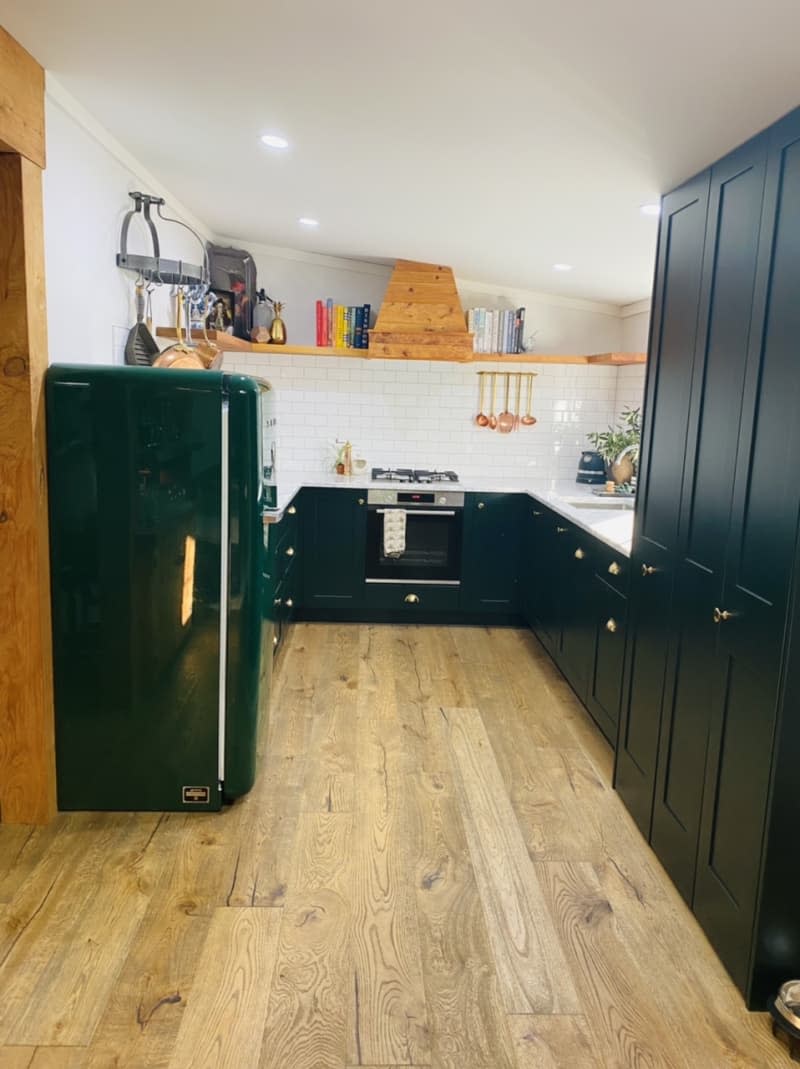 Kitchen with dark cabinetry and green Smeg