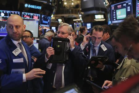 Traders work on the floor of the New York Stock Exchange (NYSE) shortly after the opening bell in New York December 17, 2015. REUTERS/Lucas Jackson