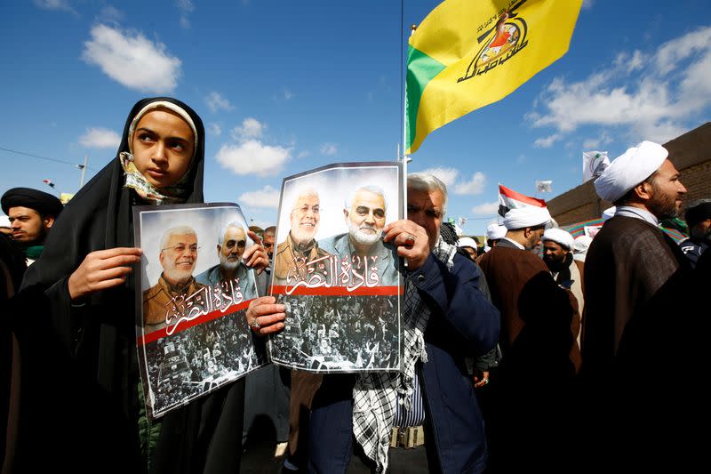 FOTO DE ARCHIVO: El pueblo iraní lleva fotos del difunto comandante de la Fuerza Quds de Irán, Qassem Soleimani, y del comandante de la milicia iraquí Abu Mahdi al-Muhandis, que murieron en un ataque aéreo de los Estados Unidos en el aeropuerto de Bagdad, durante los cuarenta días de conmemoración en el cementerio "Valle de la Paz" en Najaf, Irak, el 11 de febrero de 2020