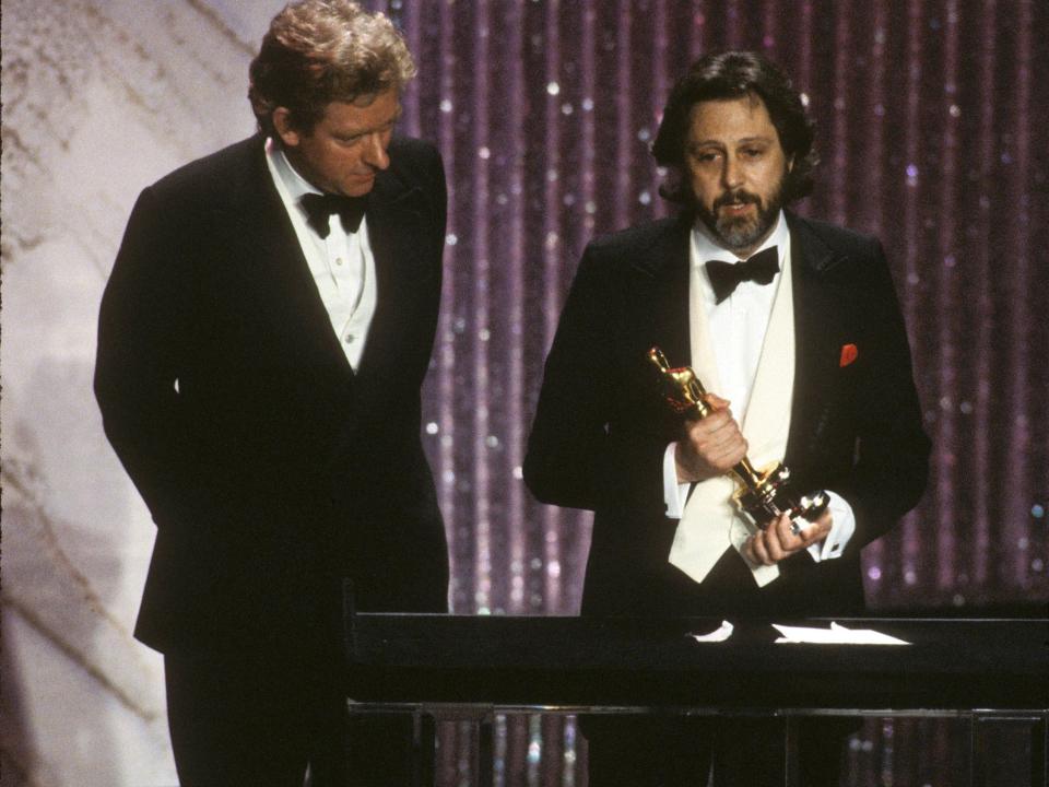 THE 54TH ANNUAL ACADEMY AWARDS - Broadcast Coverage - Airdate: March 29, 1982. (Photo by ABC Photo Archives/Disney General Entertainment Content via Getty Images) DIRECTOR HUGH HUDSON (L) AND PRODUCER DAVID PUTTNAM WITH BEST PICTURE OSCAR FOR "CHARIOTS OF FIRE"