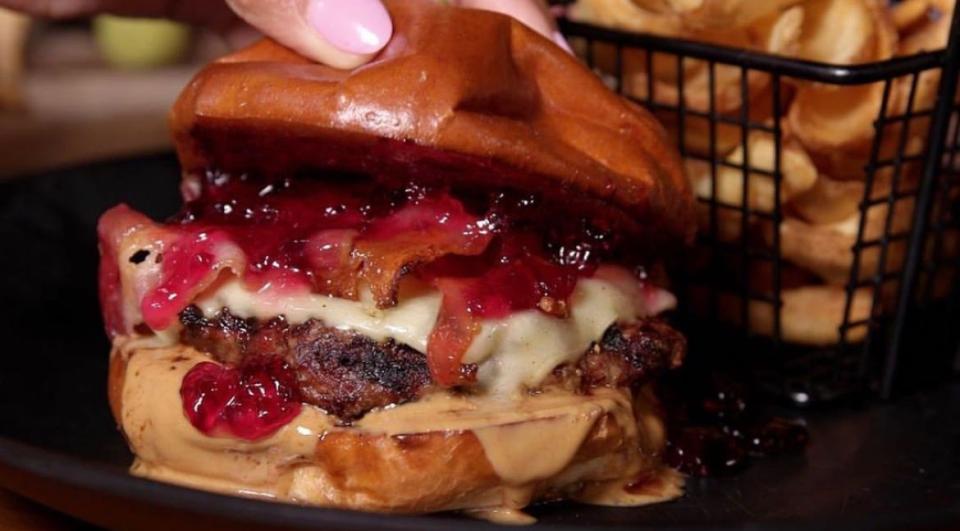 Riverhouse in Taunton's Peanut Butter Jelly Time Burger comes with peanut butter, jelly, bacon, and American cheese, and is served with Riverhouse’s scoop fries.