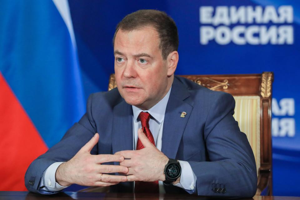 Dmitry Medvedev sits at a desk during a meeting. 