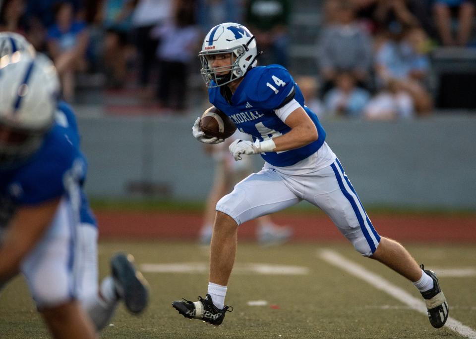 Memorial’s Will Pedtke (14) runs the ball as the Memorial Tigers play the Mater Dei Wildcats at Enlow Field Friday, Sept. 8, 2023.