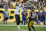 New York Jets quarterback Zach Wilson (2) makes a touchdown catch as Pittsburgh Steelers safety Minkah Fitzpatrick (39) defends during the first half of an NFL football game, Sunday, Oct. 2, 2022, in Pittsburgh. (AP Photo/Gene J. Puskar)