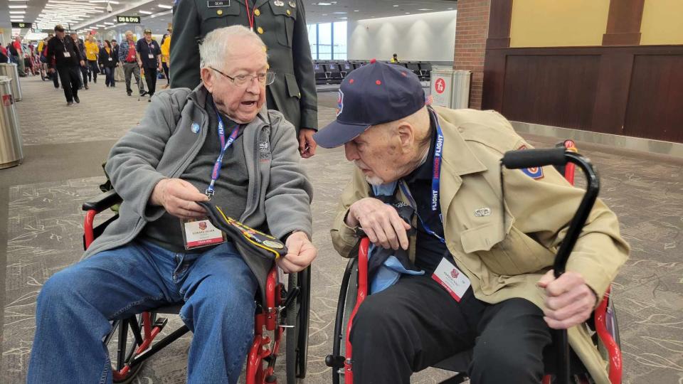 World War II veterans Edward Julian Austin, left, and Hal Hogstrom chat at Baltimore-Washington International Airport in Baltimore.