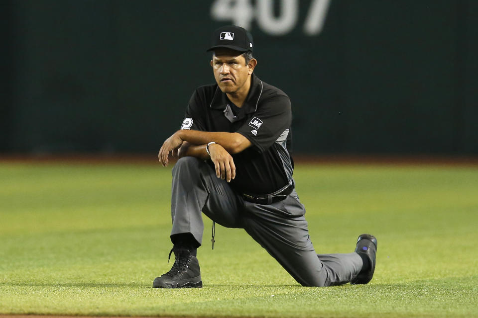 FILE - In this Aug. 8, 2019, file photo, Major League baseball umpire Alfonso Marquez is shown during the first inning of a baseball game between the Arizona Diamondbacks and the San Francisco Giants in Phoenix. Kerwin Danley became the first African American umpire crew chief in Major League Baseball during a series of retirements, promotions and additions announced Thursday, Feb. 27, 2020. The moves included Alfonso Marquez being elevated to the second Hispanic crew chief in MLB history. (AP Photo/Rick Scuteri, File)