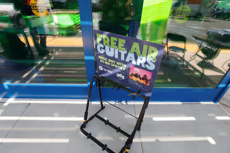 A sign advertising free air guitars is pictured outside a 365 by Whole Foods Market grocery store ahead of its opening day in Los Angeles, U.S., May 24, 2016. REUTERS/Mario Anzuoni