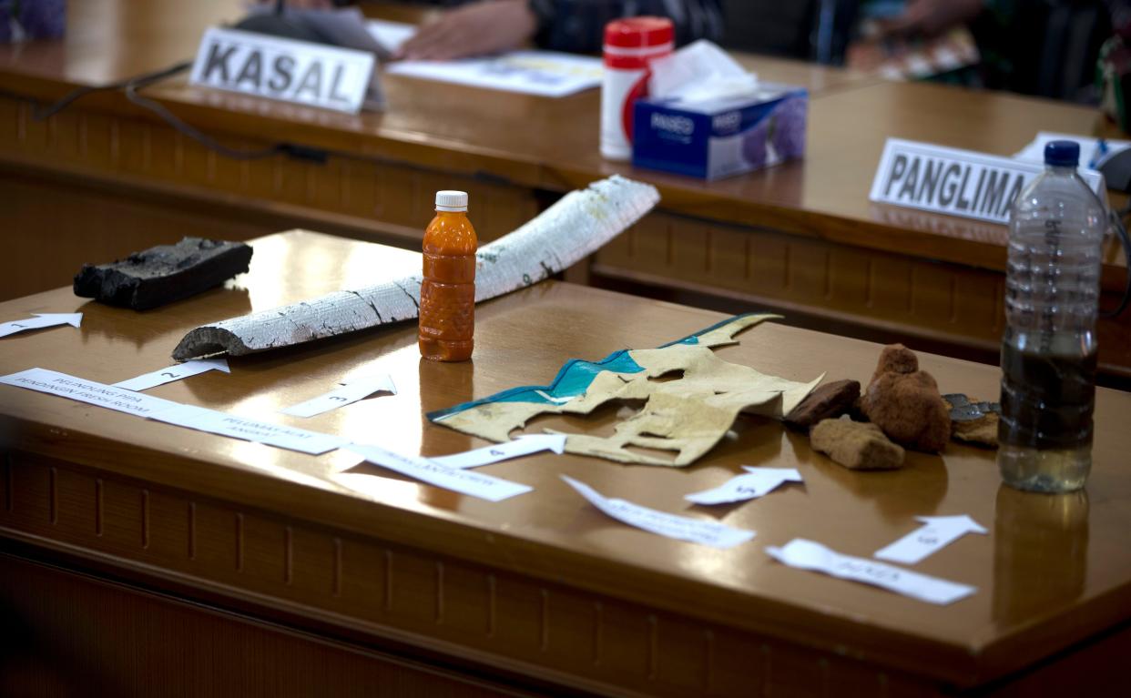 Items found in the waters are seen on desk during a press conference for the missing Indonesian Navy submarine KRI Nanggala at Ngurah Rai Military Air Base in Bali on Saturday.