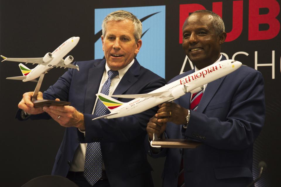 Boeing Co. Senior Vice President Brad McMullen, left, and Ethiopian Airlines Group CEO Mesfin Tasew hold Boeing aircraft models at the Dubai Air Show in Dubai, United Arab Emirates, Tuesday, Nov. 14, 2023. Ethiopian Airlines said Tuesday it was buying 31 aircraft from Boeing, including 20 737 MAX aircraft in a sign of renewed confidence in the single-aisle aircraft by the carrier after it suffered a deadly crash in 2019 with the airplane that led to its worldwide grounding. (AP Photo/Jon Gambrell)