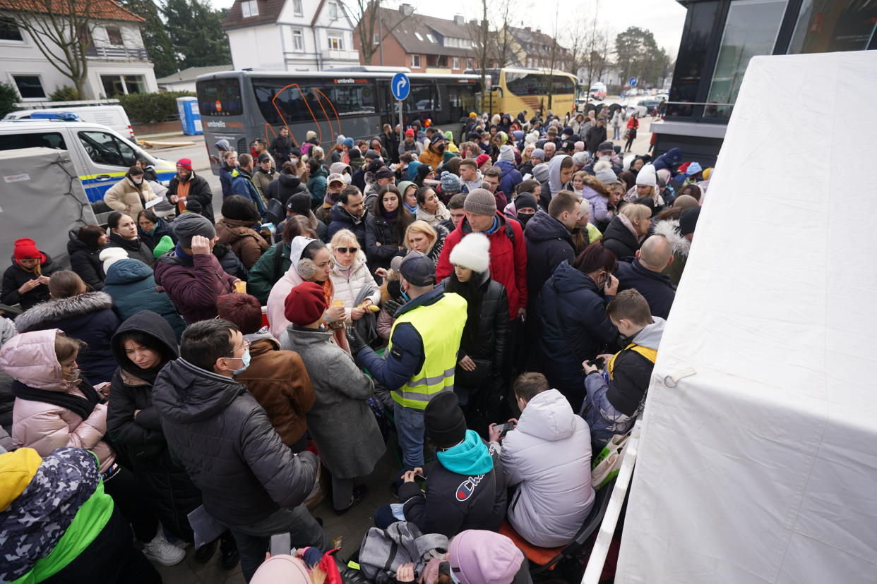 Refugees from Ukrainian wait for admission in front of the registration office for refugees inn Hamburg, Germany, Monday, March 14, 2022. Germany's Interior Ministry said Monday that it has so far registered 146,998 refugees from Ukraine coming to the country, but the real number may differ if people didn't register or moved on to another country. (Marcus Brandt/dpa via AP)