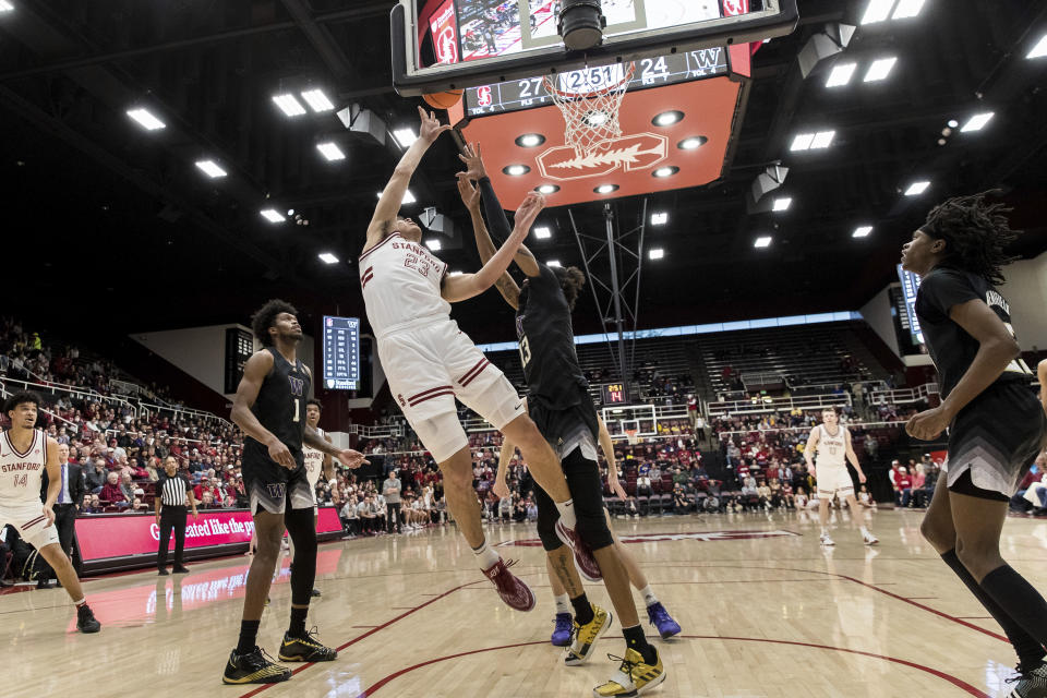 Stanford forward Brandon Angel (23) is fouled by Washington forward Langston Wilson (13) during the first half of an NCAA college basketball game in Stanford, Calif., Sunday, Feb. 26, 2023. (AP Photo/John Hefti)