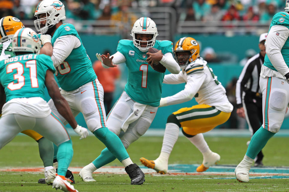 Miami Dolphins quarterback Tua Tagovailoa runs with the ball against the Green Bay Packers during the first half at Hard Rock Stadium on Sunday, Dec. 25, 2022, in Miami Gardens, Florida. / Credit: Sun Sentinel