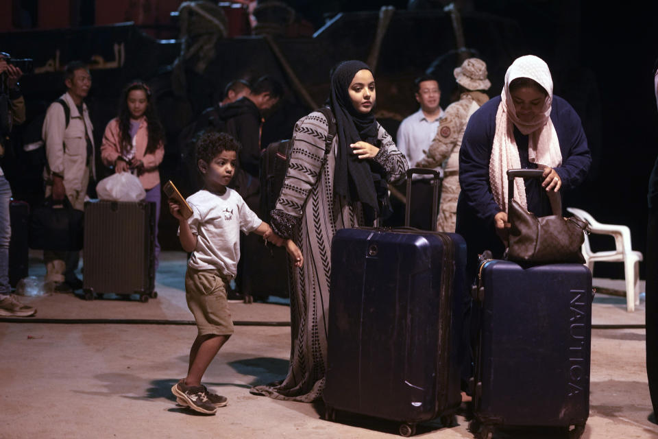 Sudanese evacuees wait before boarding a Saudi military ship to Jeddah port, at Port Sudan, in Sudan, late Tuesday, May 2, 2023. Many are fleeing the conflict in Sudan between the military and a rival paramilitary force. (AP Photo/Amr Nabil)