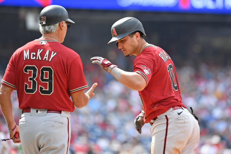 Jun 12, 2022; Philadelphia, Pennsylvania, USA; Arizona Diamondbacks third baseman Josh Rojas (10) celebrates his RBI single with first base coach Dave McKay (39) against the Philadelphia Phillies during the sixth inning at Citizens Bank Park.