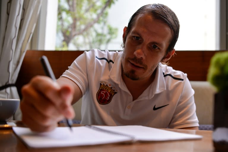 Shanghai SIPG football club director Mads Davidsen takes notes during an interview in Shanghai, on August 7, 2017