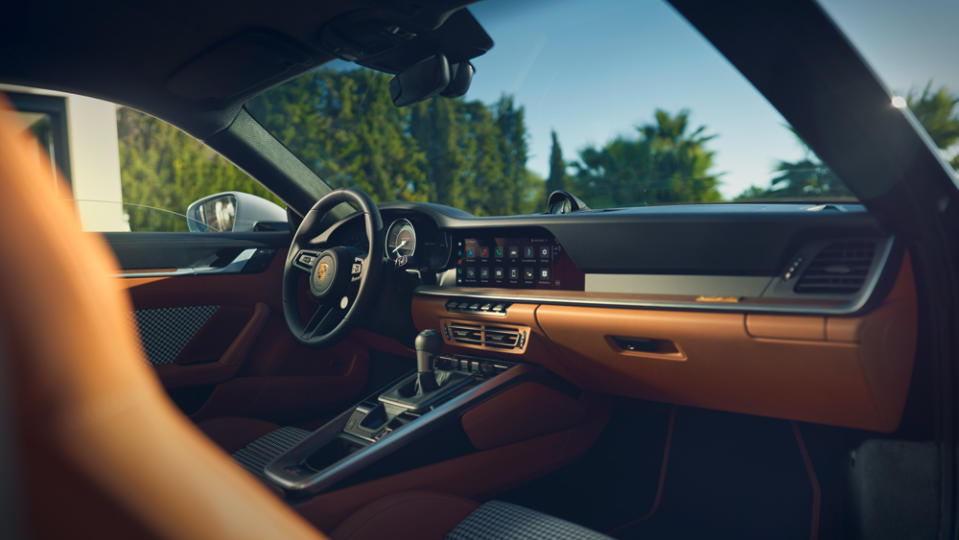 The interior is dressed with semi-aniline leather in black and Classic Cognac. - Credit: Porsche AG