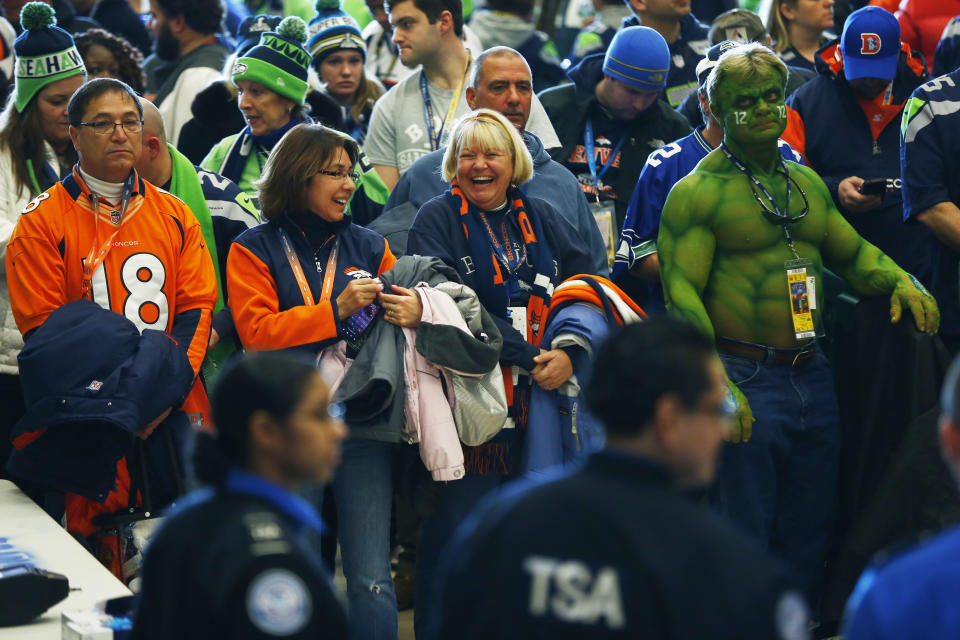 Football fans wait to go through security at the Secaucus Junction, Sunday, Feb. 2, 2014, in Secaucus, N.J. The Seattle Seahawks are scheduled to play the Denver Broncos in the NFL Super Bowl XLVIII football game on Sunday at MetLife Stadium in East Rutherford, N.J. (AP Photo/Matt Rourke)