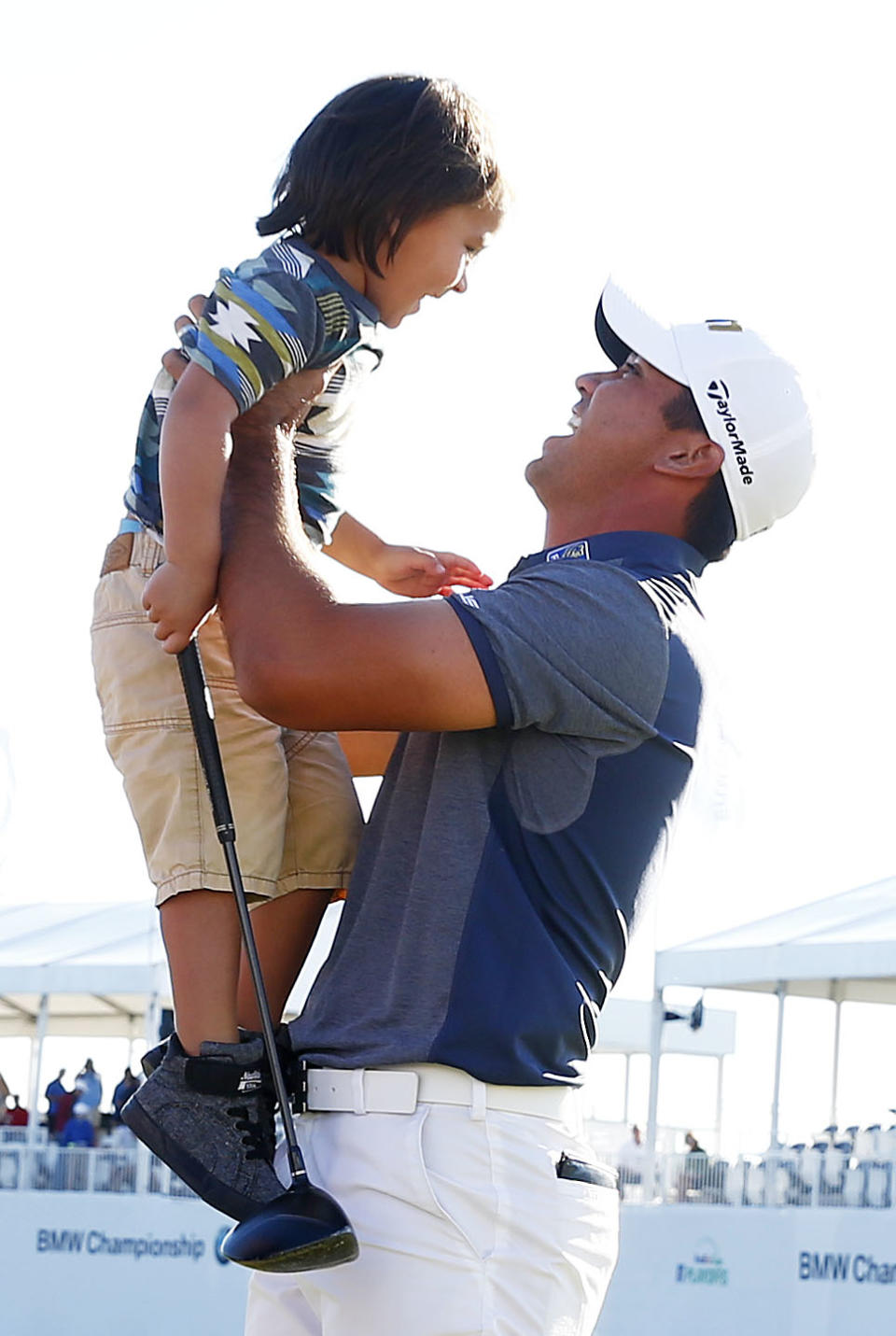 <p>Jason Day of Australia celebrates with his son Dash after winning during the Final Round of the BMW Championship at Conway Farms Golf Club on September 20, 2015 in Lake Forest, Illinois. (Photo by Jamie Squire/Getty Images) </p>