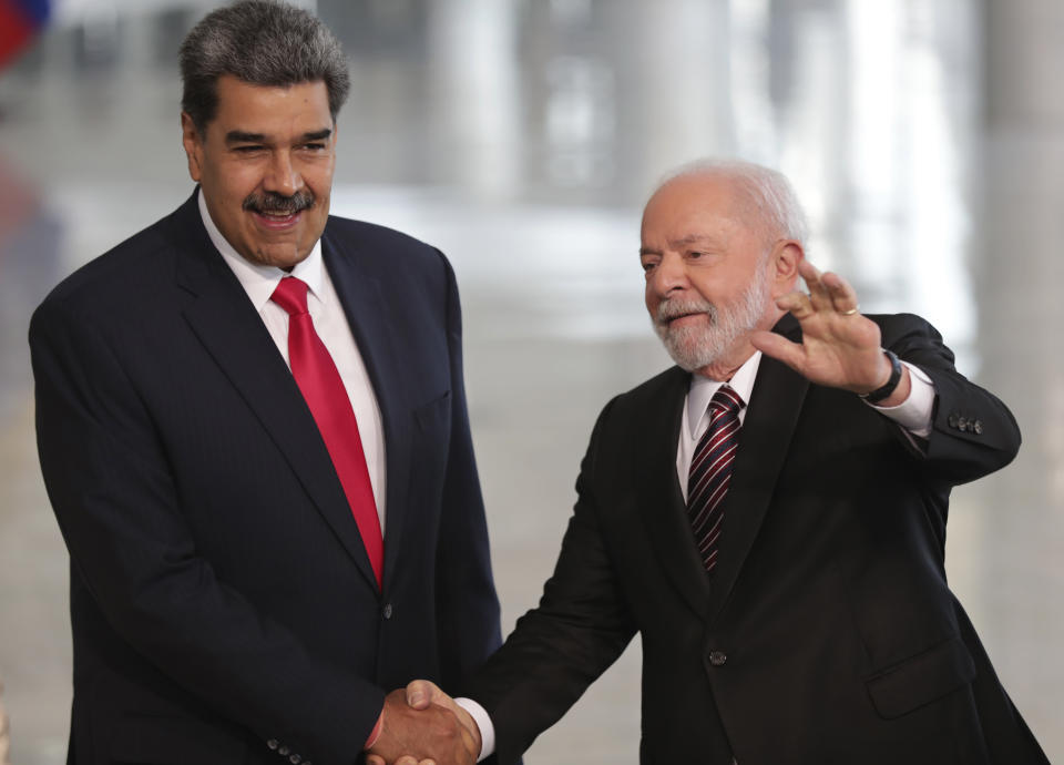 Brazilian President Luiz Inacio Lula da Silva, right, shakes hands with Venezuela's President Nicolas Maduro prior to their bilateral meeting at Planalto palace in Brasilia, Brazil, Monday, May 29, 2023. Maduro is in Brazil for the Union of South American Nations (UNASUR) summit that starts on Tuesday. (AP Photo/Gustavo Moreno)