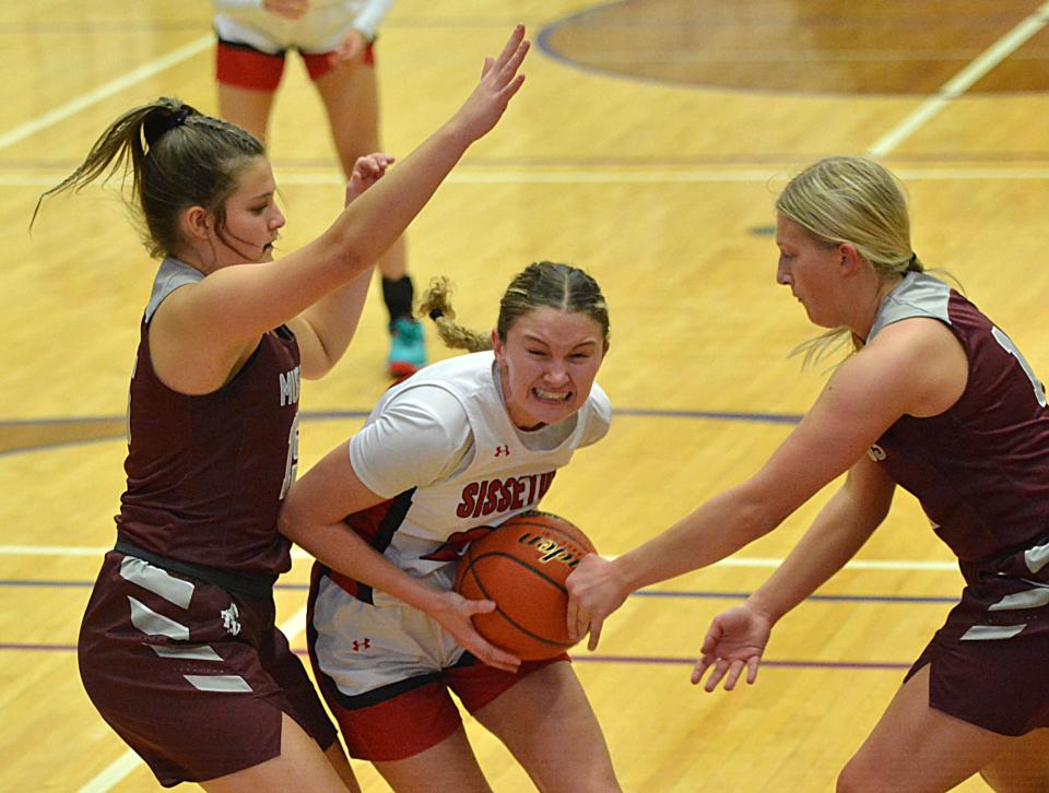 Sisseton's Emmalee Nielsen drives between Tri-Valley defenders Hailey Sorenson (left) and Lauren Grinde during their Class A SoDak 16 girls basketball game on Thursday, Feb. 29, 2024 in the Watertown Civic Arena. Sisseton won 63-52.