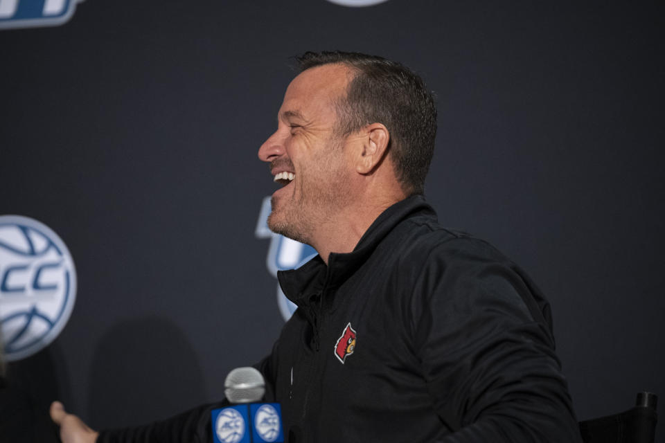 Louisville head coach Jeff Walz laughs during NCAA college basketball Atlantic Coast Conference media day, Wednesday, Oct. 13, 2021, in Charlotte, N.C. (AP Photo/Matt Kelley)