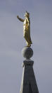 The Angel Moroni statue is shown atop the Salt Lake Temple of The Church of Jesus Christ of Latter-day Saints Saturday, April 4, 2020, in Salt Lake City. The twice-annual conference kicked off Saturday without anyone attending in person and top leaders sitting some 6 feet apart inside an empty room as the faith takes precautions to avoid the spread of the coronavirus. A livestream of the conference showed a few of the faith's top leaders sitting alone inside a small auditorium in Salt Lake City, Normally, top leaders sit side-by-side on stage with the religion's well-known choir behind them and some 20,000 people watching. (AP Photo/Rick Bowmer)