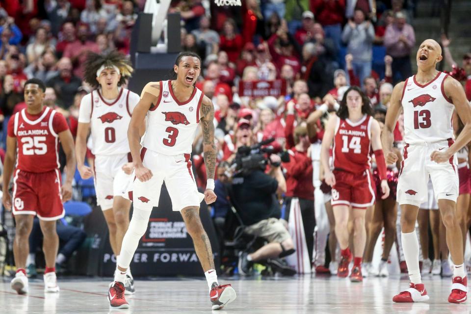 Arkansas guards Nick Smith Jr. (3) and Jordan Walsh (13) celebrate after Smith Jr.'s dunk during an 88-78 win against Oklahoma on Saturday at the BOK Center in Tulsa.