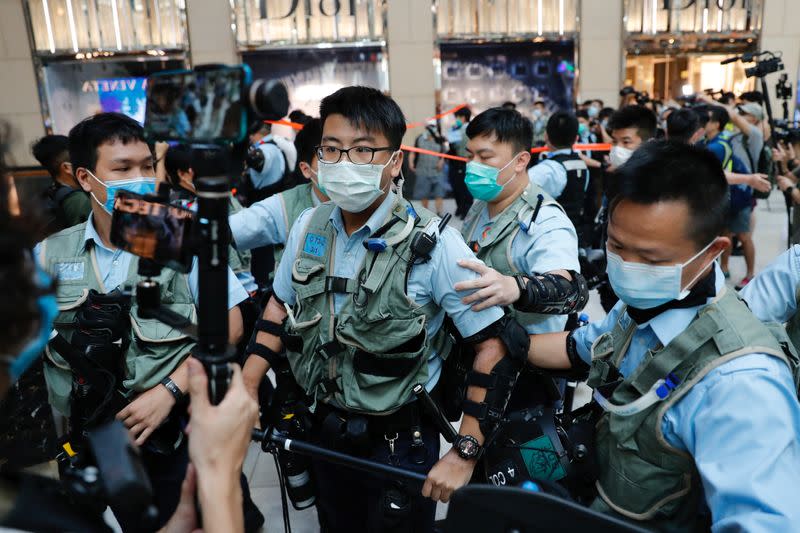 Police officers ask people to leave during a protest after China's parliament passes a national security law for Hong Kong