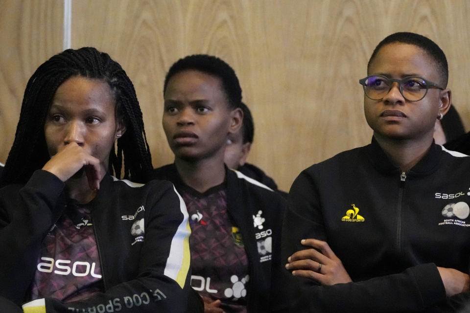 Refiloe Jane, captain for the South Africa's Women's World Cup, right, sits with teammates as they attend a joint media briefing in Johannesburg, South Africa, Wednesday, July 5, 2023. A foundation set up by African soccer president and billionaire businessman Patrice Motsepe stepped in Wednesday to resolve a pay dispute between South Africa's Women's World Cup players and their national association, ensuring they will get on a plane and head to the tournament in Australia and New Zealand. (AP Photo/Themba Hadebe)