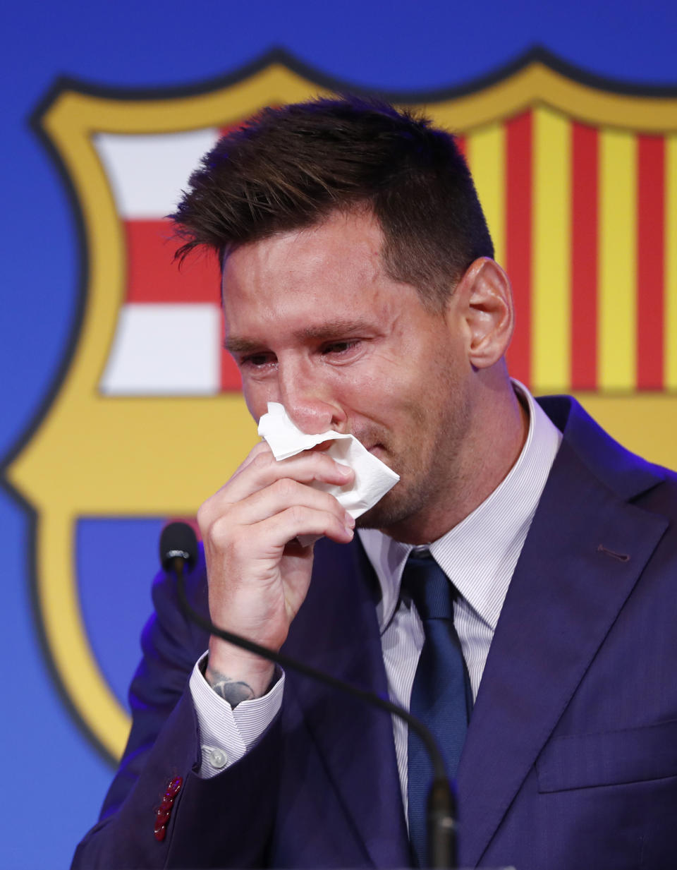 Lionel Messi cries at the start of a press conference at the Camp Nou stadium in Barcelona, Spain, Sunday, Aug. 8, 2021. FC Barcelona had previously announced the negotiations with Lionel Messi had ended and that Messi would be leaving the club. (AP Photo/Joan Monfort)