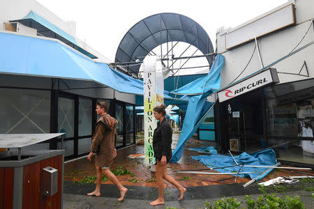 People walk past damaged shops after Cyclone Debbie hit Airlie Beach. AAP/Dan Peled/via REUTERS
