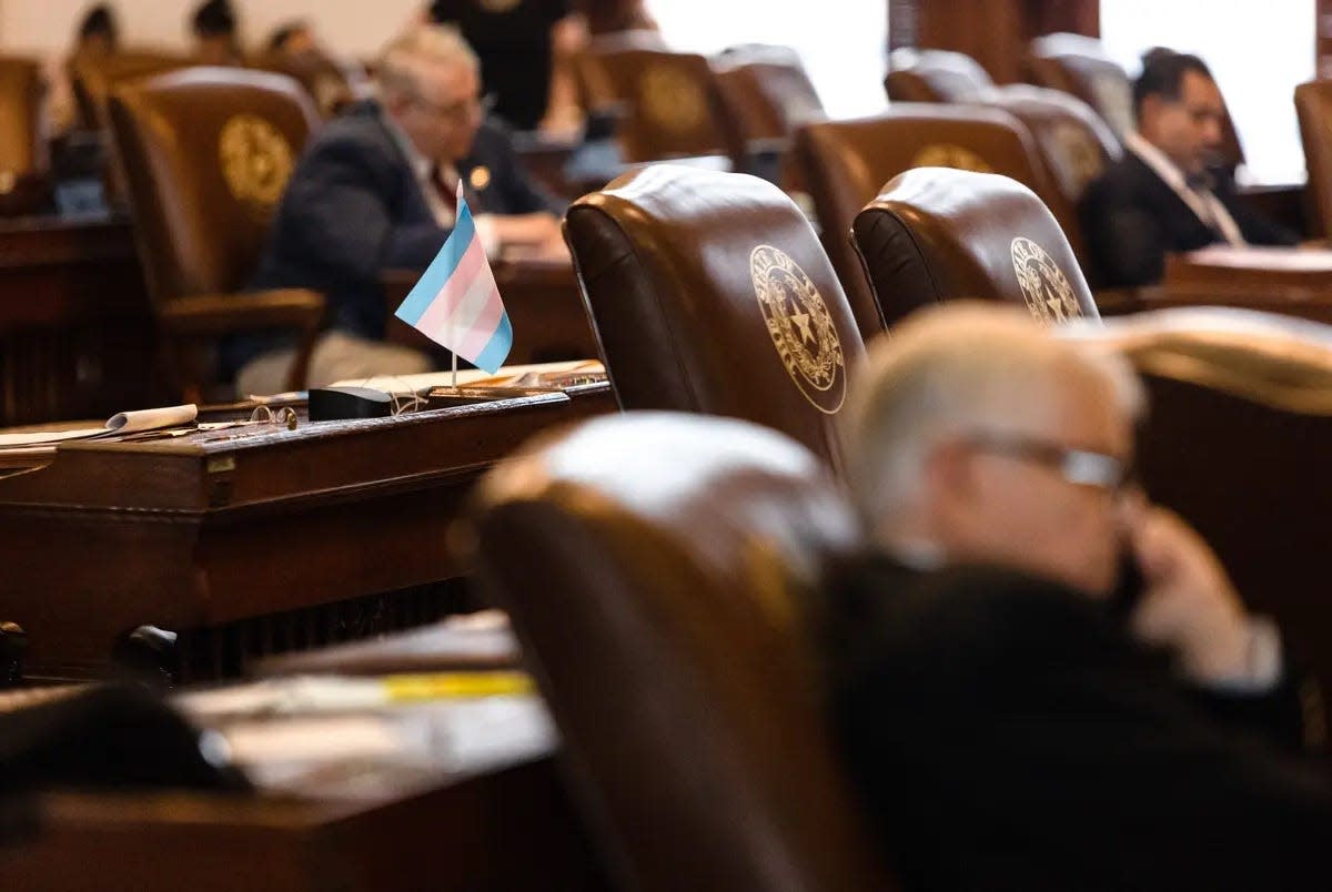 A transgender pride flag sits on the desk of a lawmaker during debate on Senate Bill 14, which bans puberty blockers and hormone therapy for trans kids.