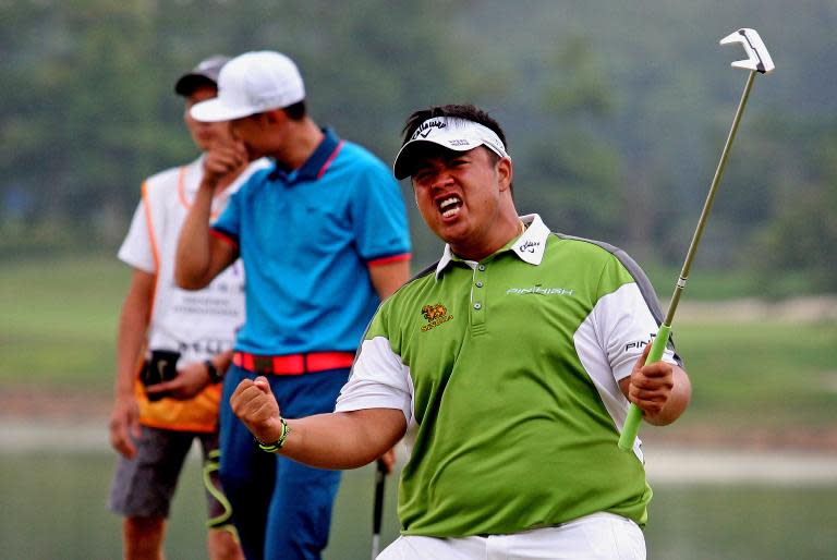 Kiradech Aphibarnrat of Thailand celebrates after beating Li Haotong of China on the playoff hole to win the Shenzhen International golf tournament on April 19, 2015