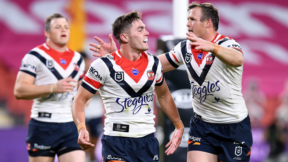 Roosters halfback Kyle Flanagan is seen here celebrates with teammates during an NRL game.