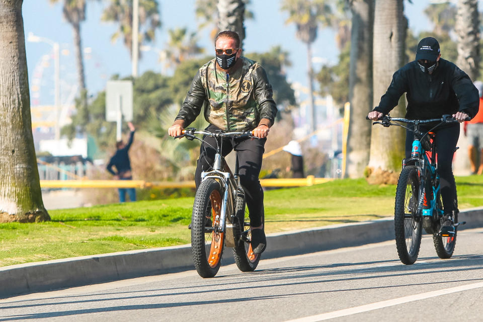 <p>Arnold Schwarzenegger takes a bike ride in L.A. on Friday wearing a camo jacket. </p>