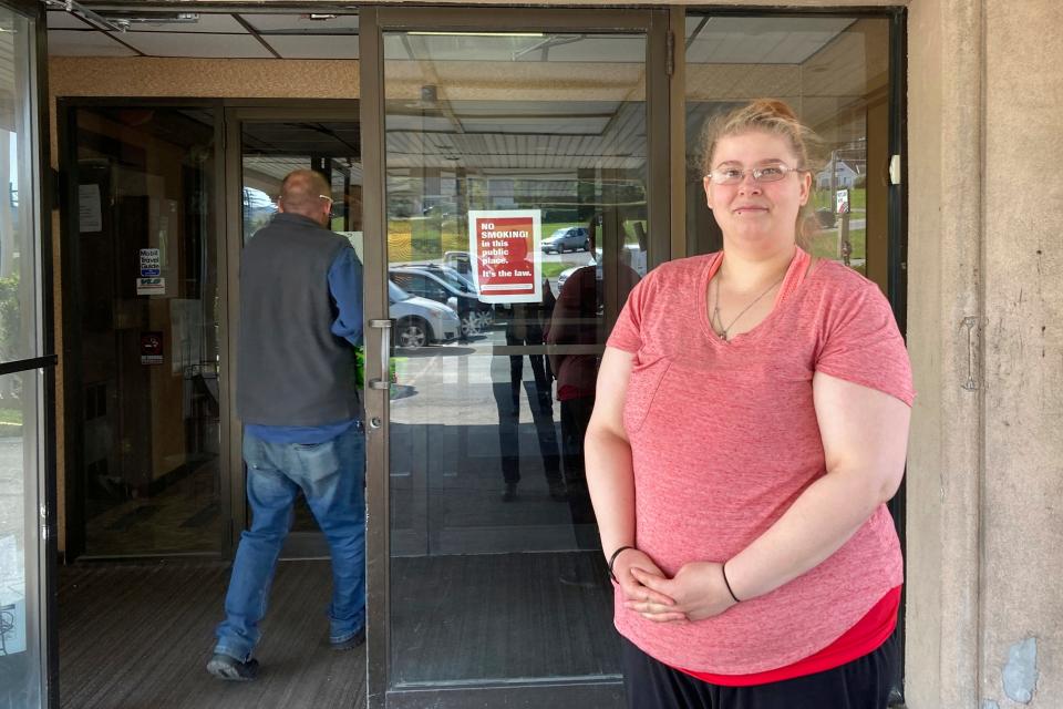 Brittany Plucas stands, Tuesday, May 9, 2023, outside the Hilltop Inn in Berlin, Vt., where she and her boyfriend have been staying since they became homeless in April 2023. Vermont’s pandemic-era expansion of the emergency housing program is ending soon and Plucas and her boyfriend will likely sleep in her car.