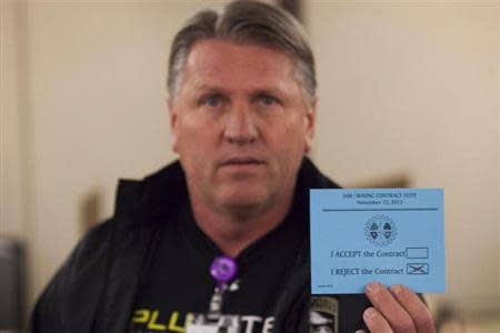 A union member displays his vote against the proposed contract during a union vote at the International Association of Machinists District 751 Headquarters in Seattle, Washington by the association's members on a proposed contract by the Boeing Company to build the 777X jetliner November 13, 2013. REUTERS/David Ryder