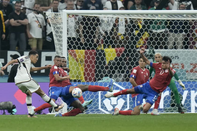 Germany's Jamal Musiala, left, kicks a ball during the World Cup group E soccer match between Costa Rica and Germany at the Al Bayt Stadium in Al Khor , Qatar, Thursday, Dec. 1, 2022. (AP Photo/Hassan Ammar)