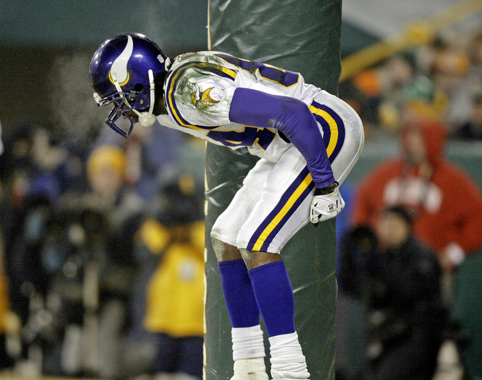 Minnesota Vikings receiver Randy Moss bends over to the crowd after catching a 34-yard touchdown pass on Jan. 9, 2005 against the Packers. (AP Photo/Morry Gash)