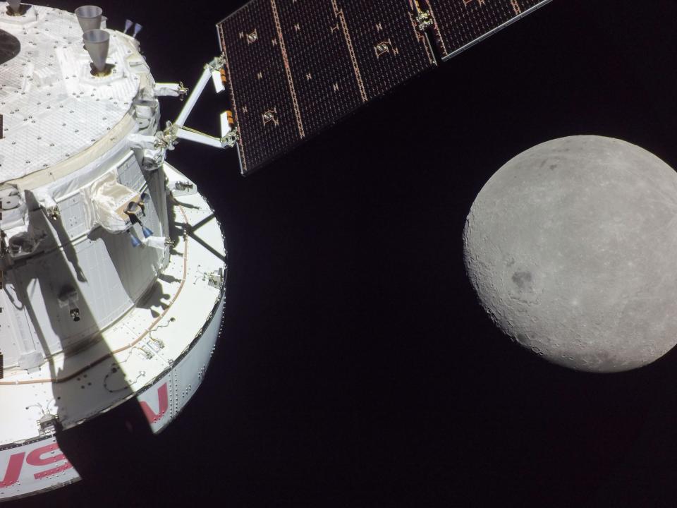 A portion of the far side of the Moon looms large just beyond the Orion spacecraft in this image taken on the sixth day of the Artemis I mission by a camera on the tip of one of Orion’s solar arrays. The spacecraft entered the lunar sphere of influence Sunday, Nov. 20, making the Moon, instead of Earth, the main gravitational force acting on the spacecraft. On Monday, Nov. 21, it came within 80 miles of the lunar surface, the closest approach of the uncrewed Artemis I mission, before moving into a distant retrograde orbit around the Moon. The darkest spot visible near the middle of the image is Mare Orientale.