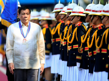 Philippine President Rodrigo Duterte reviews honour guards upon arrival as an honorary guest for the 116th Police Service Anniversary inside the Philippine National Police (PNP) headquarters in Quezon city, metro Manila, Philippines August 9, 2017. REUTERS/Romeo Ranoco