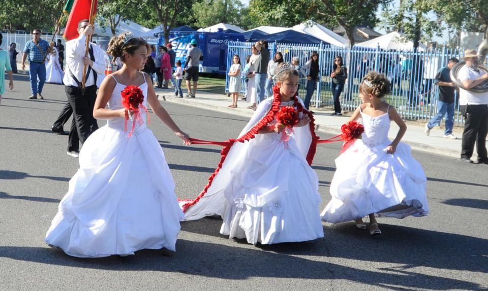 Pictured is Tulare Holy Ghost Festa Queen Brianne Azevedo, 9, center, surrounded by her attendants: Victoria Vieira, 11, and Hanna Vieira, 8, in Tulare, California.