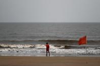 Lifeguard walks along the shore off the Arabian Sea before cyclone Nisarga makes its landfall, in Mumbai