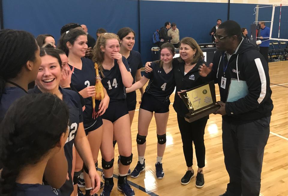 The Immaculate Heart Academy girls volleyball team accepts the Non-Public A championship trophy from NJSIAA assistant director Derryk Sellers. IHA defeated Paul VI, 25-16, 23-25, 25-23, on Sunday, Nov. 13, 2022 in Franklin Township.